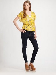 This cheery floral top offers a figure-flattering fit with cinched waist and feminine butterfly sleeves. Cross-over v-neckDropped shouldersShort butterfly sleevesDrop elasticized waistRuffle hemSilkDry cleanImportedModel shown is 5'10 (177cm) wearing US size Small.