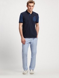 Soft and simple, with an unexpected sleeve and chest pocket detail.Three-buttonCottonMachine washImported
