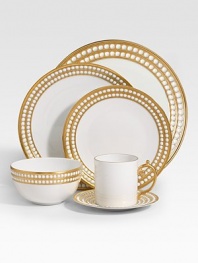 A beautiful dinner plate in fine Limoges porcelain, made entirely by hand and finished with individually-applied 14k gold along the pearl border. From the Perlee Gold Collection Porcelain 10½ diam. Dishwasher safe Imported 