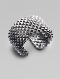 A dramatic cuff design, with a stud-like texture and a stunning finish of black rhodium over sterling silver. Black rhodium-finished sterling silver Diameter, about 2½ Width, about 1¾ Hinged Imported