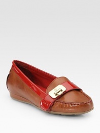 Moccasin-inspired leather with vibrant patent leather trim and a unique, hinge-adorned buckle strap. Leather and patent leather upperLeather liningRubber solePadded insoleImportedOUR FIT MODEL RECOMMENDS ordering one half size down as this style runs large. 