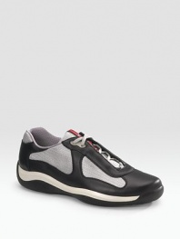 Lace-up sneaker with leather and mesh upper on a rubber sole. Padded insole Molded rubber bottom Imported 