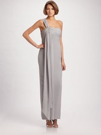 A single ruched chiffon strap wraps around the bodice of this silk style, then flows into a floor-length drape.Asymmetrical neckline Single ruched strap with long drape and jeweled detail Concealed back zip Back center slit Polyester lining 100% polyester Dry clean Imported