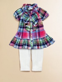 An adorable cotton plaid top, adorned with ruffle trim along the placket and collar, is paired with pointelle leggings for an unbeatable match. Shirt Ruffled collarShort raglan sleevesButton frontRuffle hem Leggings Elastic waistbandPicot trim along hemCottonMachine washImported Please note: Number of buttons may vary depending on size ordered. Additional InformationKid's Apparel Size Guide 