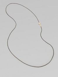 A simple oxidized sterling silver chain with a 14k gold cross, attached sideways for a modern look. 14k goldOxidized sterling silverLength, about 26Slip-on style Made in USA 