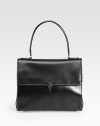 Sumptuously-sleek leather in a demure flap silhouette, edged with scalloped trim.Top handle, 6½ dropMagnetic snap flap closureProtective metal feetOne inside zip pocketOne inside open pocketLeather lining11¾W X 9½H X 5¾DMade in Italy