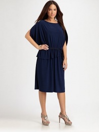 Simply sophisticated, this design has it all: an alluring neckline, flattering arm coverage, comfortable elasticized waist and a fashion-forward asymmetrical hem.Round necklineShort sleevesElasticized waistAsymmetrical hemAbout 27 from natural waist96% polyester/4% elastaneDry cleanImported