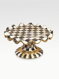 A beautifully handcrafted ceramic stand in a checkerboard juxtaposition of ivory and onyx with gold luster. The perfect accompaniment to a cake, pie or quiche is fired three times for added strength to last a lifetime. Fluted edges Hand-painted and -glazed 6½H X 12 diam. Hand wash Made in USA 