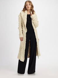 Exquisitely crafted in Aran knit, this sweeping cardigan style features an elegant shawl collar and a self-belt.Shawl collarLong sleeves with rib-knit cuffsSingle button closureSelf tie beltSide welt pocketsAbout 37 from shoulder to hem70% merino wool/30% silkDry cleanImported
