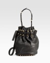 Bold studs and rugged pebble leather join forces in a drawstring bucket bag with lots of attitude. Adjustable leather shoulder strap, 17-21 dropDrawstring closureOne outside open pocketProtective metal feetOne inside zip pocketFully linedLeather14½W X 12H X 8DImported
