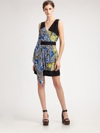 A graphic floral print in a two-tone color combination with pleated and draped front panel.V-neck Wrap front Pleated, draped front panel Banded waist and hem Gathered rear yoke About 20 from natural waist Silk; dry clean Imported Additional Information Women's Premier Designer & Contemporary Size Guide 