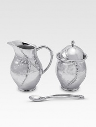 A handmade creamer and sugar set in hammered, sandcast aluminum, buffed by hand for unparalleled shine and elegance. Set includes sugar bowl with lid, creamer and matching spoon Creamer, 4½H X 3 diam. Sugar, 4½H X 3 diam. Spoon, 5 long Sandcast aluminum Food safe Hand wash Imported 