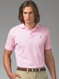 A year-round essential, the iconic polo in soft mercerized pima cotton has a gentle fit for the ultimate in comfort. Mercerized yearns for smooth hand and subtle luster Two-button placket Ribbed polo collar and armbands Multi-color polo detail at chest Silk grosgrain taping at split hem Machine wash Imported