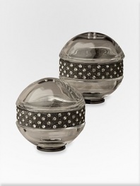 A pair of richly detailed platinum salt and pepper shakers are hand-embellished with faceted Swarovski crystals that add a jeweled touch to any table. From the Noir Collection Hand wipe Imported