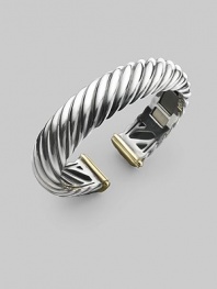From the Carved Cable Collection. A bold cable cuff of sterling silver, richly accented with touches of 18k gold. Sterling silver and 18k yellow gold Cable, 15mm Diameter, about 2¼ Hinged Imported