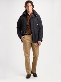 A trim-fitting jacket designed in water-resistant technical fabric and outfitted with a detachable hood and plenty of pockets for a contemporary touch. Zip front with snap storm flap Detachable hood Metal grommets under the arms Sleeve, chest zip pockets Waist flap pockets Fully lined About 28 from shoulder to hem Polyester Dry clean Imported 