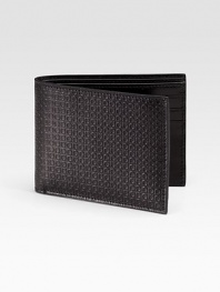 Sleek, slim design rendered in stamped calfskin leather.One billfold compartmentSix credit card slots4½ x 3¼Made in Italy