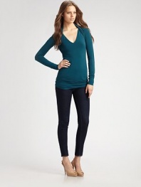 Body-skimming stretch knit, finished with layered shrug shoulders.V neckline Long sleeves Ruched back panels About 28 from shoulder to hem 94% rayon/6% spandex Dry clean Made in USA