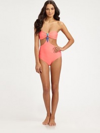 An exotic swim style that shows just the right amount of skin, thanks to sexy cutout details. Bandeau topCutout detailsBeaded centerBack clasp closureFully lined80% nylon/20% spandexHand washImported