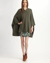 Cozy wool style with three-quarter poncho sleeves and a hi-low hem. Crossover neckline Three-quarter poncho sleeves Hi-low hem Merino wool Dry clean Imported