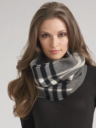 Ultra-soft cashmere snood in large oversized check can be accessorized with outerwear or worn on its own. One size fits most Cashmere; dry clean Imported
