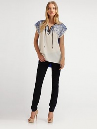 Geometric embroidery lends a unique touch of modern detail to this breezy shift, finished with a solid contrast back.Split T neckline with tie closureDropped shouldersPullover styleAbout 27 from shoulder to hemPolyesterDry cleanImported