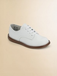The timeless choice, expertly crafted in durable leather with excellent support and comfort.Leather upper Adjustable laces Padded insole Rubber traction sole Imported Please note: It is recommended that you order ½ size smaller than measured. If your child measures a size 7.0, you may want to order a 6½. 