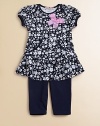A floral ruffled tunic with pockets complements a matching pair of soft leggings.Envelope necklineShort cap sleevesPullover styleKangaroo pocketsSkirted hemElastic waistbandLogo embroideryTunic: 65% cotton/35% rayonLeggings: 94% cotton/6% spandexMachine washImportedAdditional InformationKid's Apparel Size Guide 