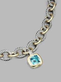 From the Albion Collection. A brilliant blue topaz, richly faceted, surrounded by 18k gold and set in sterling silver. Blue topaz 18k yellow gold and sterling silver About ½ square Hinged clip clasp Made in USA Please note: Necklace sold separately.