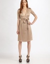 Trench-inspired styling lends a classic edge to this tailored silk style.Plunging surplice necklineEpaulettesButton-down gunflapsShort sleevesSelf tie beltAbout 25½ from natural waistSilkDry cleanImported