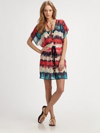 A bohemian-chic style with a flattering, elastic waistband and tie front detail. Deep plunge v-neckShort kimono sleevesElastic waistline with tie detailSide slits74% cotton/26% silkDry cleanMade in USA of Italian fabricsAdditional Information Women's Premier Designer & Contemporary Size Guide 