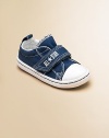 Cute, comfy classics with grip-tape closure in a denim design that'll add a little coolness to any ensemble.Grip-tape closureCanvas upperCanvas liningRubber soleTraditional Chuck insoleImported