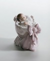 A sweet baby girl in a basket, just welcomed into the world. Crafted by Lladró, Spain's most esteemed artisans of porcelain figurines.