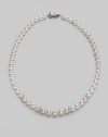 From the Akoya Collection. A graduated strand of white, round cultured Akoya pearls with diamond rondels set in 18k white gold. 7mm-9mm white round pearls Quality: A1 Diamonds, 0.08 tcw 18k white gold Length, about 18 Mikimoto signature clasp Imported