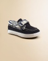 Classic boat shoes get a stylish update with grip-tape closure, lace trim and an embroidered pony.Hook-and-loop grip-tape closureCotton canvas upperPlush terry liningRubber solePadded insoleImported