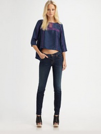 Embroidered silk boatneck with a playfully cropped front hem and cutout details at the neckline. Boatneck with cutout detailsThree-quarter sleevesCropped front hemSilkDry cleanImportedModel shown is 5'10 (177cm) wearing US size Small.