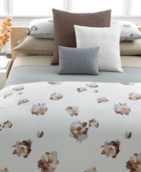 A mixture of cool and warm tones render an abstract watercolor floral design on a pale aqua ground in this Teaflower sham from Calvin Klein.