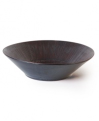 Give your table a glamorous edge with this Sunburst serving bowl. Featuring a cool ridged finish and dark, mysterious sheen in durable Nambe stoneware.