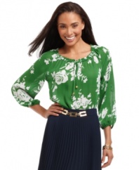 Add colorful charm to your wardrobe with this vibrant petite peasant top by Charter Club.