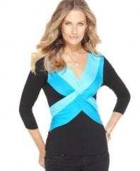 Brighten up with Cable & Gauge's twist-front top! The bold color pops against a background of flattering black.