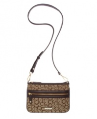 Signature jacquard distinguishes the crossbody purse by Calvin Klein. Remove the strap to carry it as a clutch.