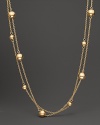 From the Pallini collection, a station bead necklace in yellow gold. With signature ruby accent. Designed by Roberto Coin.