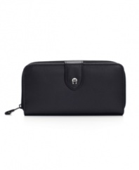 Zip around town with this zip-around frame wallet, full of nifty features, by Etienne Aigner.