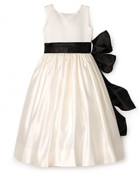 Make her day magical in this pearly Us Angels dress, featuring a classic black sash and billowy princess skirt.