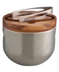 Clever design and modern materials fill the Mikko ice bucket with smart sophistication. Handsome acacia wood tops off polished stainless steel with sculpted handles for easy entertaining. Matching tongs fit neatly inside the lid. Designed by Neil Cohen for Nambe.