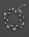 A bold sterling silver bracelet, gleaming with black onyx, is an elegant showcase for Di MODOLO's iconic Triadra design.