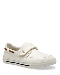 A boat shoe inspired sneaker with suede and canvas upper, hook and loop strap for easy adjustment