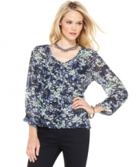 This Calvin Klein Jeans top features a chic layered look. The semi-sheer blouse is perfect with a detachable knit tank top - complete the look with skinny black pants!