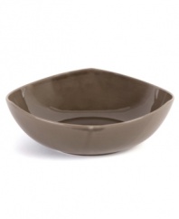 Inspired by an iconic Nambe design, this sculptural serving bowl features three gentle points in sleek, sturdy stoneware and a sophisticated espresso hue. An essential part of the Tri-Corner dinnerware collection.