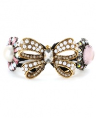 Feminine and fabulous! A large-scale bow sets the tone for this lovely, ladylike bangle bracelet from Betsey Johnson. Adorned with an array of glittering crystals, glass pearls and a black grosgrain ribbon, it's crafted in antique gold tone mixed metal. Includes a hinge closure. Approximate diameter: 2-1/2 inches.